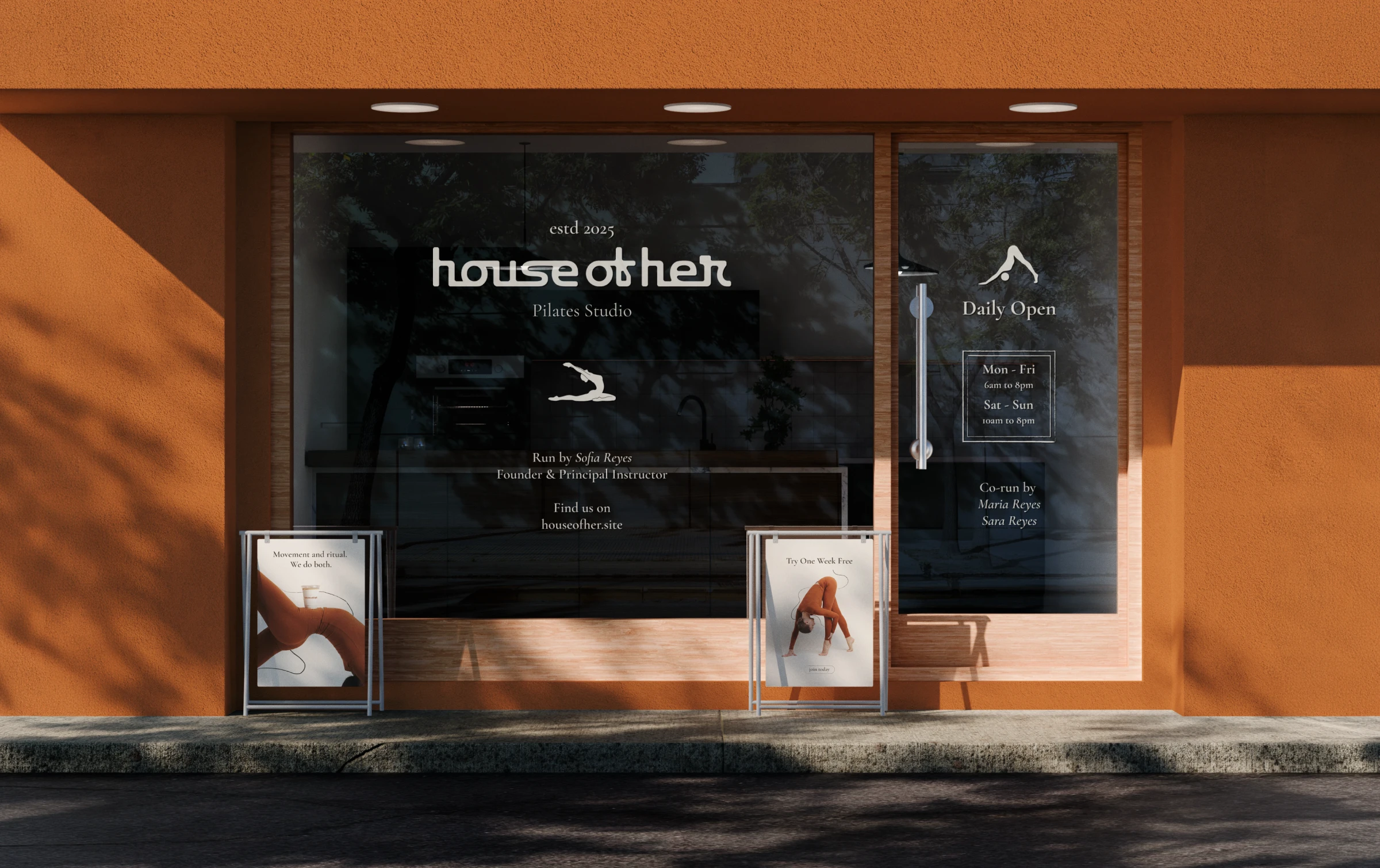 Storefront Mockup-Recovered 1 Mockup of the House of Her Pilates studio storefront with signage and opening hours in the window