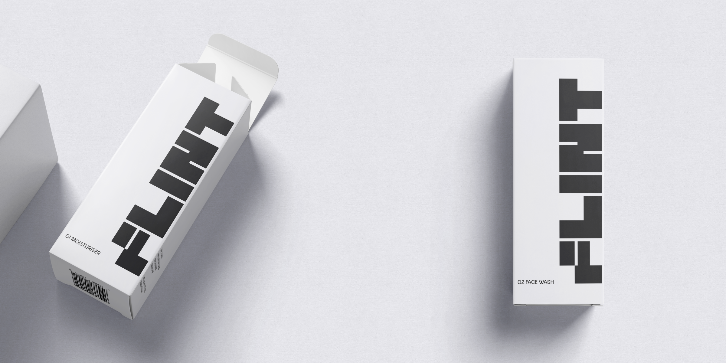 Flat lay of white Flint retail boxes for the moisturiser and face wash