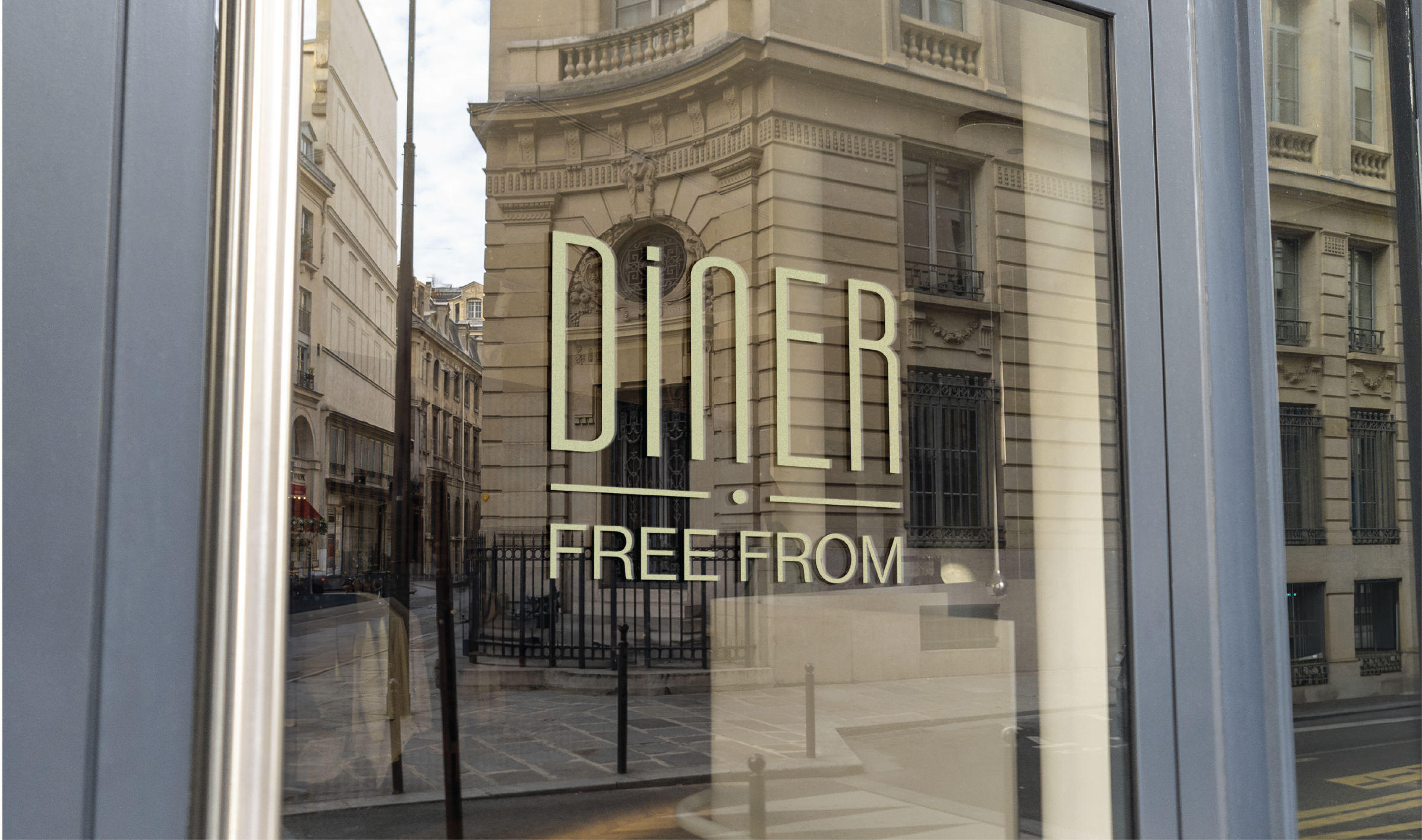 Mockup of the Diner Free From logo as window decal lettering on a shopfront