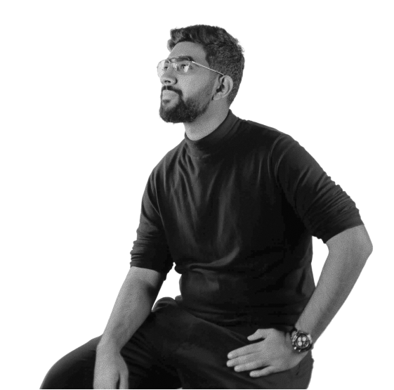 Black and white portrait of Gulraiz Hassan, founder of Kankei Studio, seated in a black turtleneck