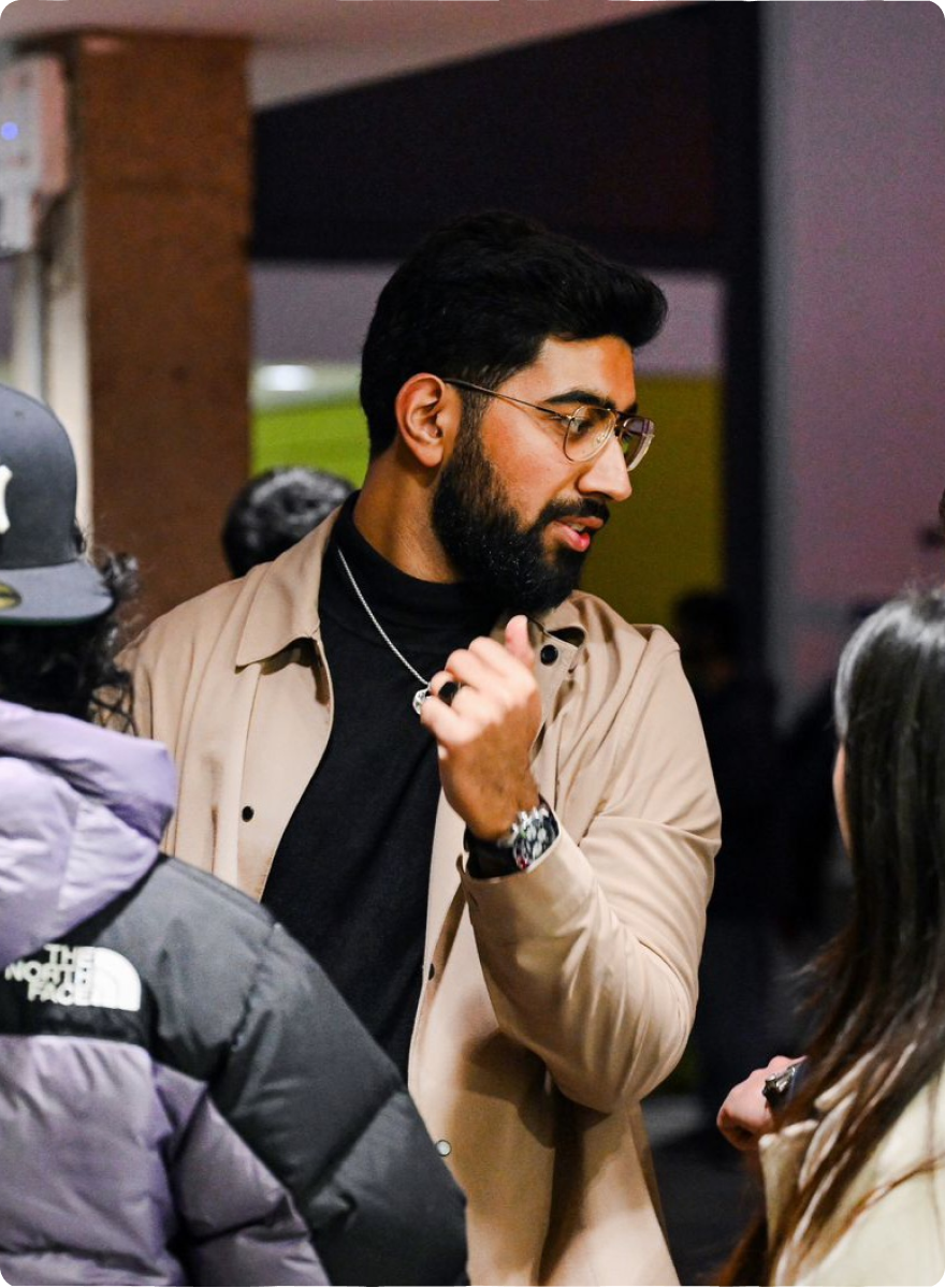 Meet Gulraiz Gulraiz Hassan talking with friends at an evening event