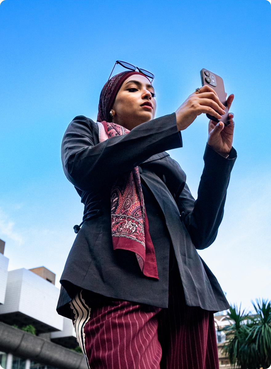 Oppo _ Nazifa 2x Woman in a headscarf on a phone call in front of the Barbican Centre, from the Oppo Reno campaign